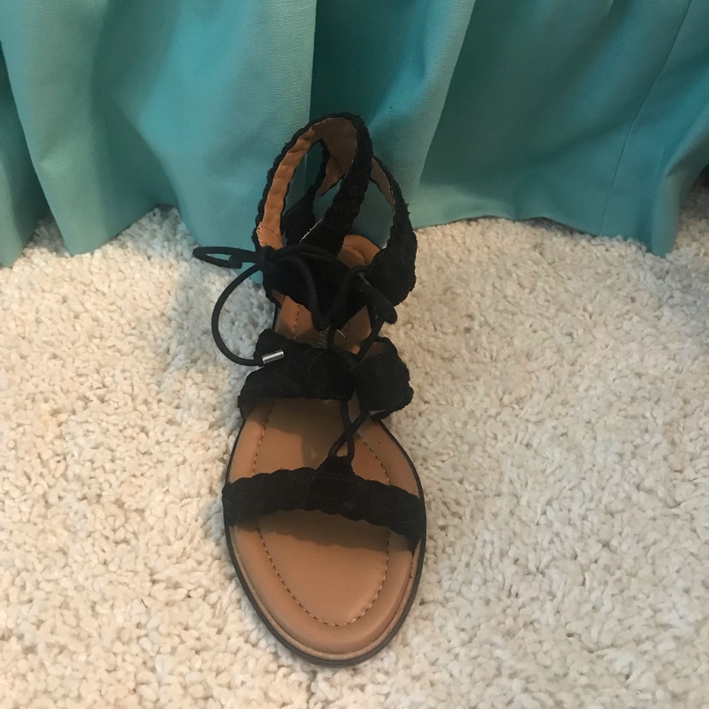 Flat black lace-up sandals